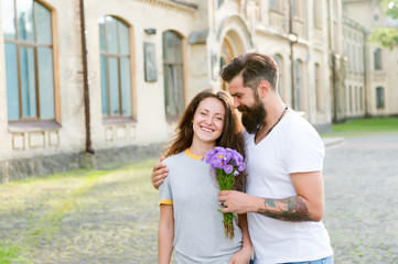 Fototapeta premium Simple happiness. Romantic date idea. Guy prepared surprise bouquet for girlfriend. True feelings. Bearded hipster fall in love. Couple meeting for date. Man giving flowers. Golden rules perfect date