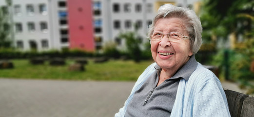 Senior Woman in Front of Residence