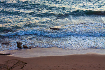 AERIAL VIEW OF THE SEA AND SHORE OF THE BEACH IN CADIZ AT SUNSET