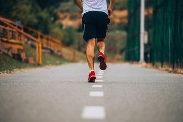 Fototapeta premium Young fitness man running in urban area