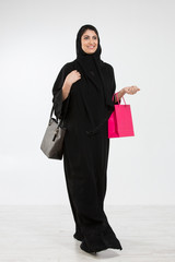 Arab woman carrying a shopping bag.