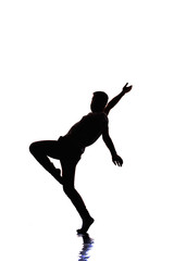 Fototapeta na wymiar Silhouette performer is doing breakdance on white wall