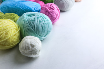 Fototapeta na wymiar Colorful yarn balls on light grey background