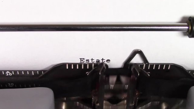 A close up video of the words "Estate Planning 101 " being typed on white paper in an old manual typewriter. Shot in macro.