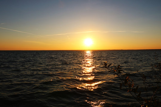 Beautiful Sunset On The Shore Of A Blue Calm Lake