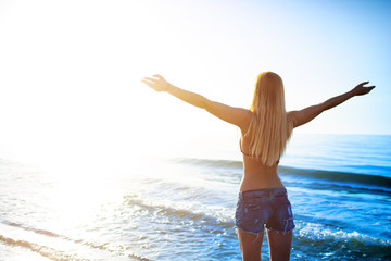Freedom girl at the beach in a sunny day