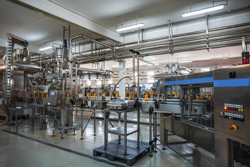 Automatic conveyor belt of production line of juice on beverage plant or factory, modern computerized industrial equipment