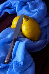 LEMONS OVER BLUE FABRIC FOULARD AND ANTIQUE KNIFE