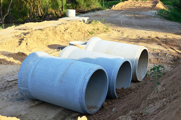 Laying or replacement of underground storm sewer pipes. Installation of water main, sanitary sewer, storm drain systems in city. Concrete drainage pipe. Utility Infrastructure - Image