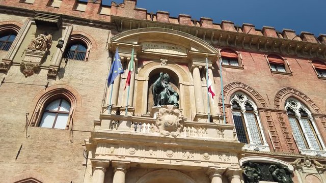 Close up of bronze statue of Pope Gregory XIII on Palace of Accursio or Comunale facade, overlooking Piazza Maggiore in Bologna, Italy.