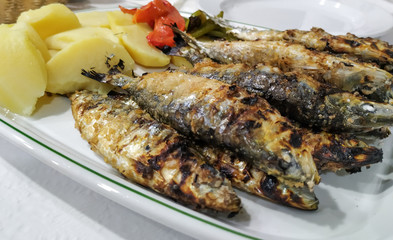 Platter of fresh grilled Portuguese sardines and vegetables