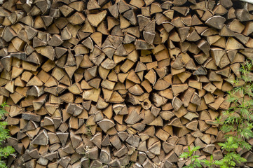 Pile firewood prepared for fireplace. Kiln dried wood for fire. Birch background