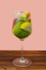 Alcoholic beverage  in wine glass. Gin tonic summer cocktail with fresh fruits. 