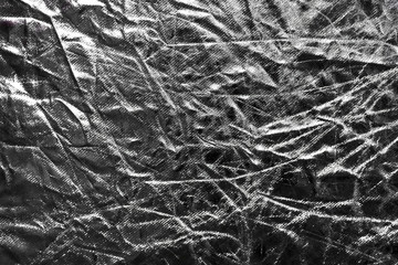 Fototapeta na wymiar The texture of the crumpled fabric is silver. Place for your text.