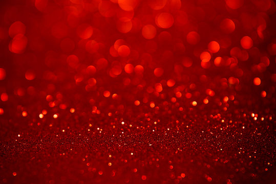 Red glitter christmas abstract background. Defocused sequin light.