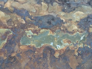 Rock heavily eroded by river water. Shifting colors and patterns. Background, overlay, or blending element.