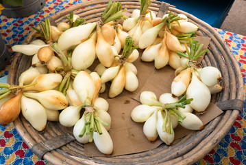 Little bunches of fresh sweet onions in a basket 