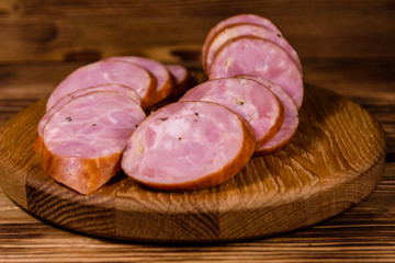Cutting board with sliced sausage on a wooden table