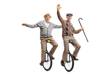 Two cheerful senior men riding unicycles © Ljupco Smokovski