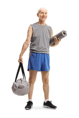 Senior man standing and holding a sports bag and an exercise mat