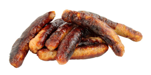 Group of grilled chipolata sausages isolated on a white background