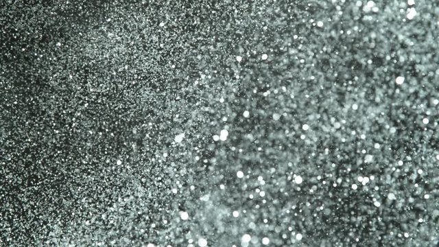 Slow motion of glittering silver particles