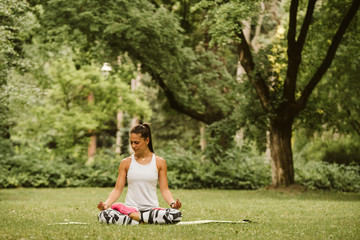  A beautiful fitness girl trains in the park. Nature and healthy life