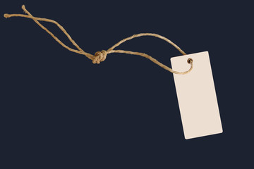 blank paper price tag or label in retro style on a beautiful twisted cord, isolated on a dark blue...