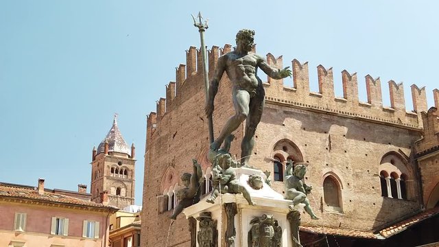 SLOW MOTION: Neptune 1567 bronze statue and fountain in front of Accursio palace of Bologna city in Emilia region of Italy.