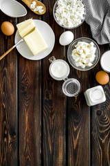Eggs, butter, milk, yougurt, cottage for natural farm products yougurt on wooden background top view copyspace