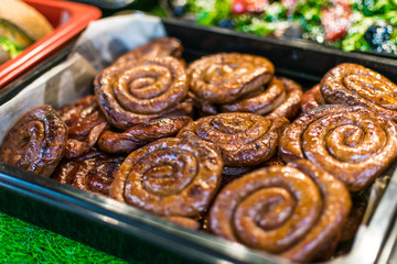 Lots of fried sausages on the counter of street vendors. Fast food.