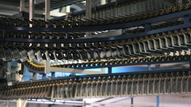 Conveyor with numerous freshly printed papers. Newspaper printed on a printing house machine.