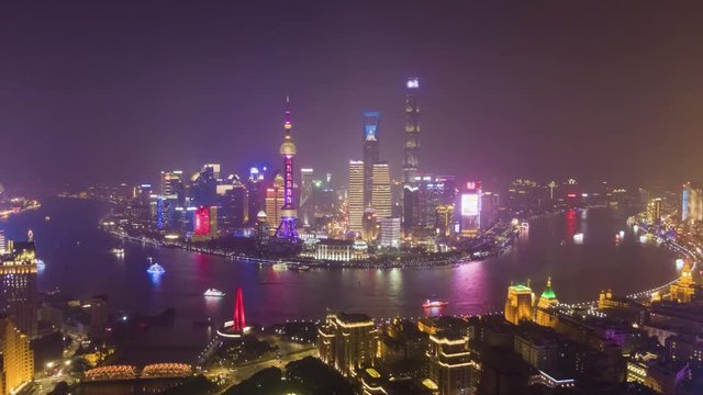 Shanghai Skyline at Night. Urban Lujiazui District, Huangpu River and Waibaidu Bridge. China. Aerial Hyper Lapse, Time Lapse. Drone is Flying Upwards and Sideways