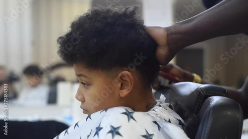 Boy In The African Barbershop Cute Mixed Boy Makes A Haircut In