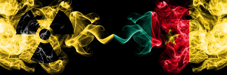 Fototapeta premium Cameroon, Cameroonian vs nuclear smoky mystic flags placed side by side. Thick colored silky smokes combination of Cameroon, Cameroonian flag and radioactive sign.