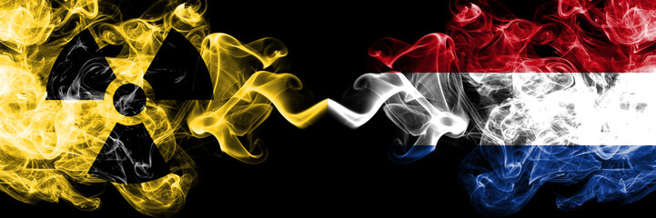 Netherlands, Dutch vs nuclear smoky mystic flags placed side by side. Thick colored silky smokes combination of Netherlands, Dutch flag and radioactive sign.