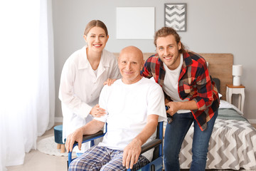 Fototapeta premium Young man visiting his father in nursing home