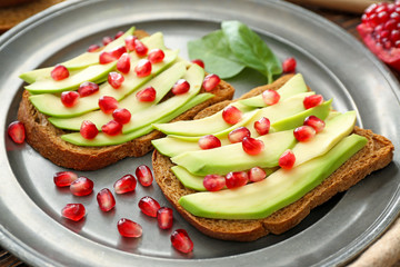 Tasty avocado toasts on plate