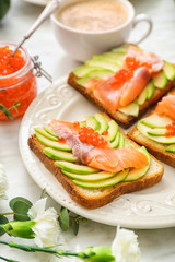 Tasty avocado toasts on plate