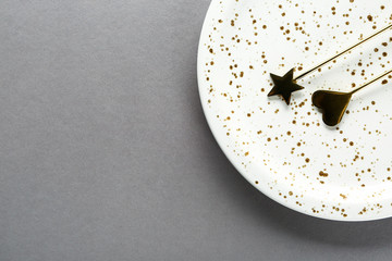 Plate with decorative sticks on grey background