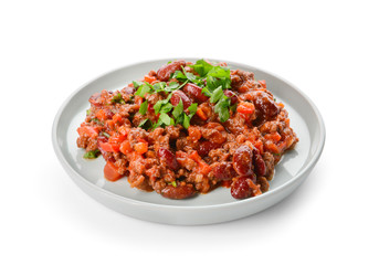 Plate with tasty chili con carne on white background
