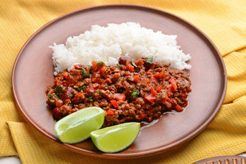 Tasty chili con carne and rice on plate, closeup