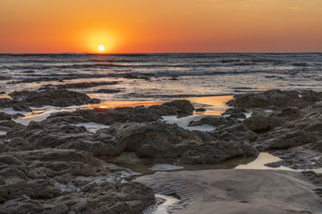 Final sunset over the ocean horizon with reflection