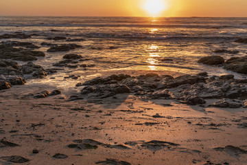 Sunset over the ocean reflecting in the water