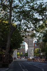 Fototapeta na wymiar New York, NY / USA - May/27/2019: People walk on a sunny summer day at Washington Square Park.