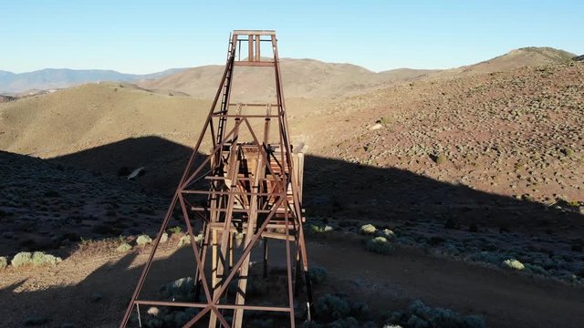 Flying Around Abandoned Gold Mine Tower Head Frame in Nevada Desert at Sunrise - Aerial Drone.
