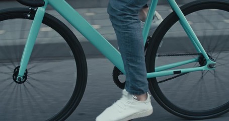Young hipster man riding bike