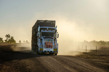 A Road Train  throws tp dust in the Australian Outback