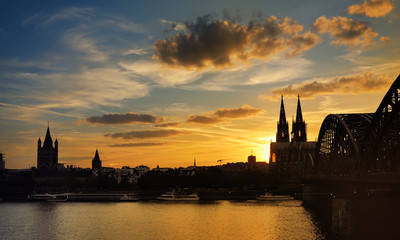 Fototapeta premium Amazing sunset view on Cologne Cathedral and Hohenzollern Bridge in Koel, Germany