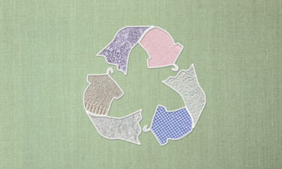 Recycle clothes symbol made with t shirt dress on hanger with stitching and recycled fabric...